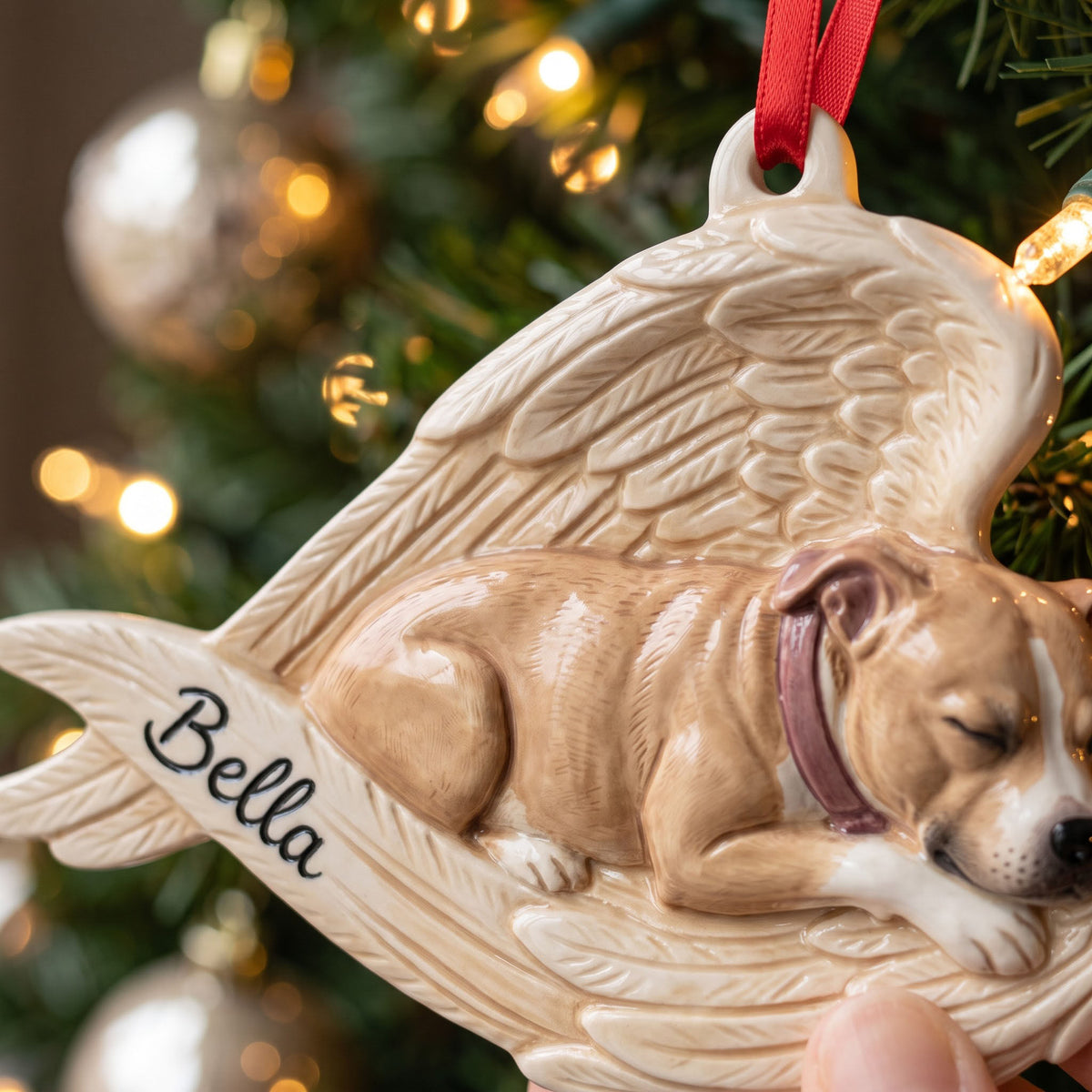 Dog memorial ornament shown in hand for scale